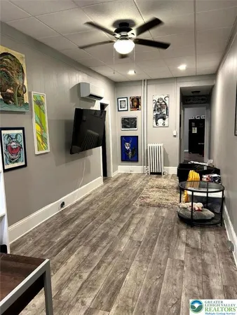 a living room with furniture and a flat screen tv