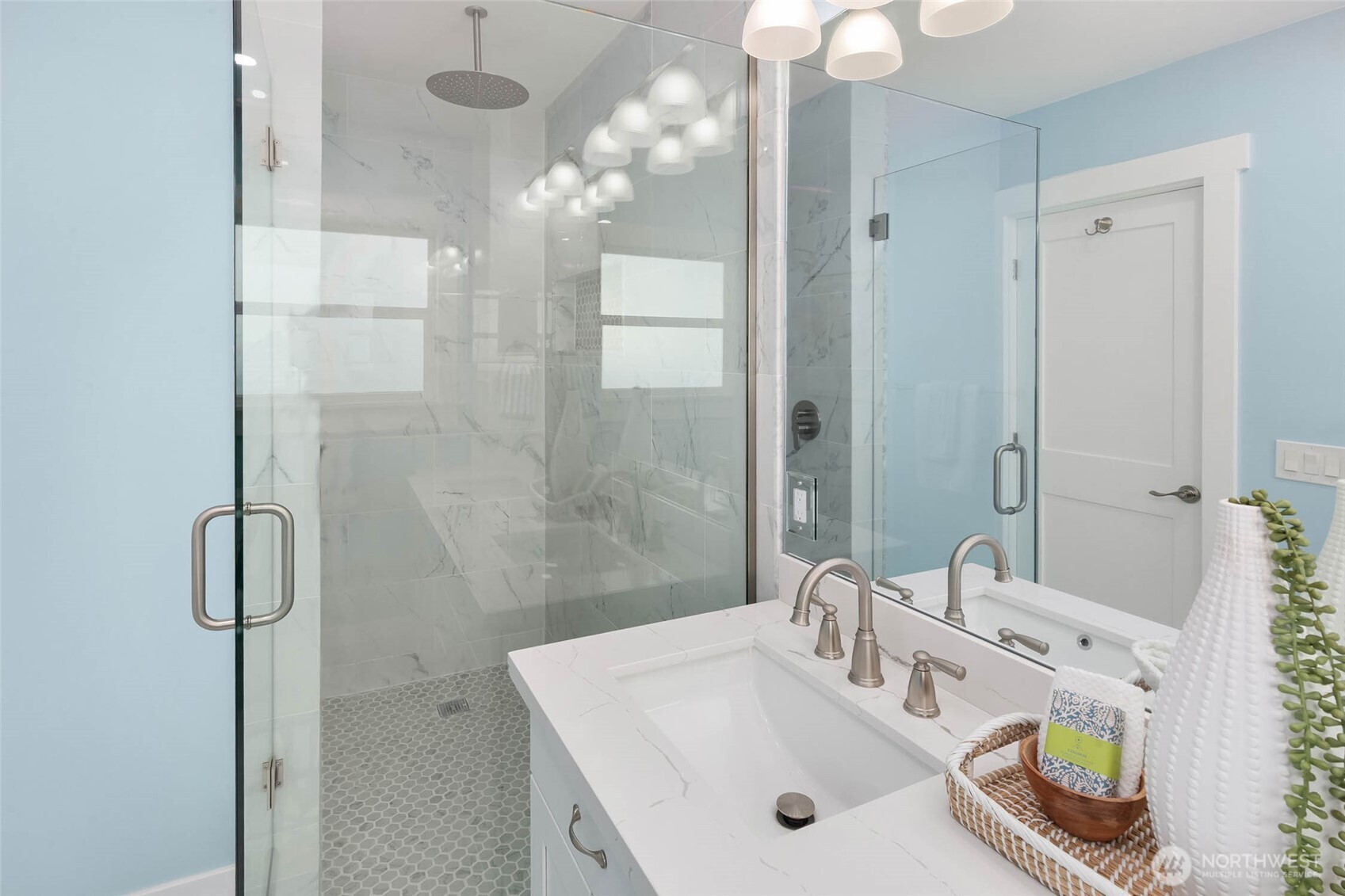 1312 Northeast 70th Street Seattle, WA 98115 - Photo 15 of 36 a bathroom with a sink a mirror and a shower