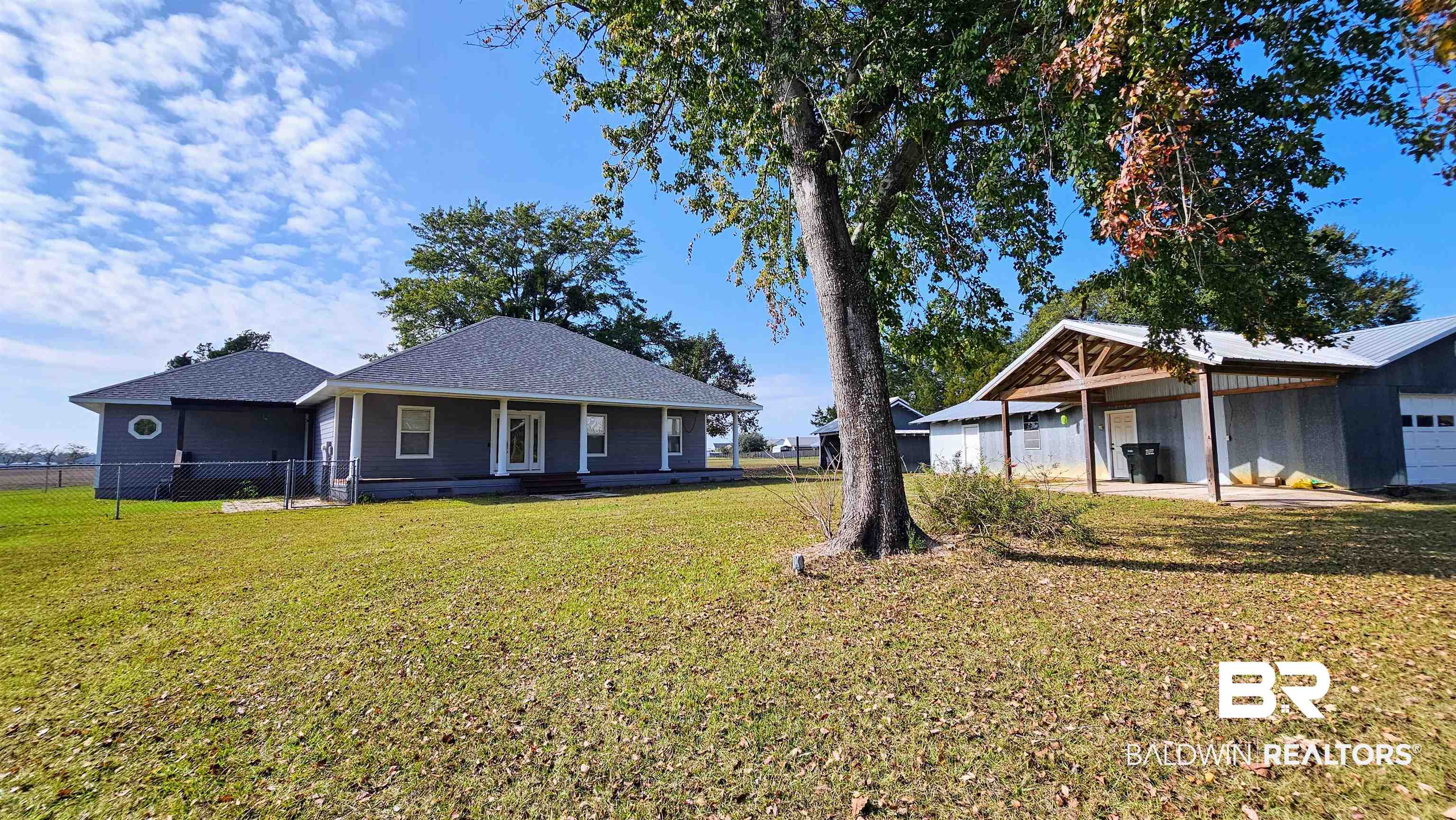 9275 Crawford Road Elberta, AL 36530 - Photo 1 of 28 View of front facade with a garage, a shingled roof, and a porch