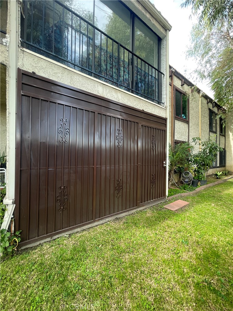4501 Peck Road, Unit 9 El Monte, CA 91732 - Photo 12 of 17 a view of backyard with potted plants and wooden fence