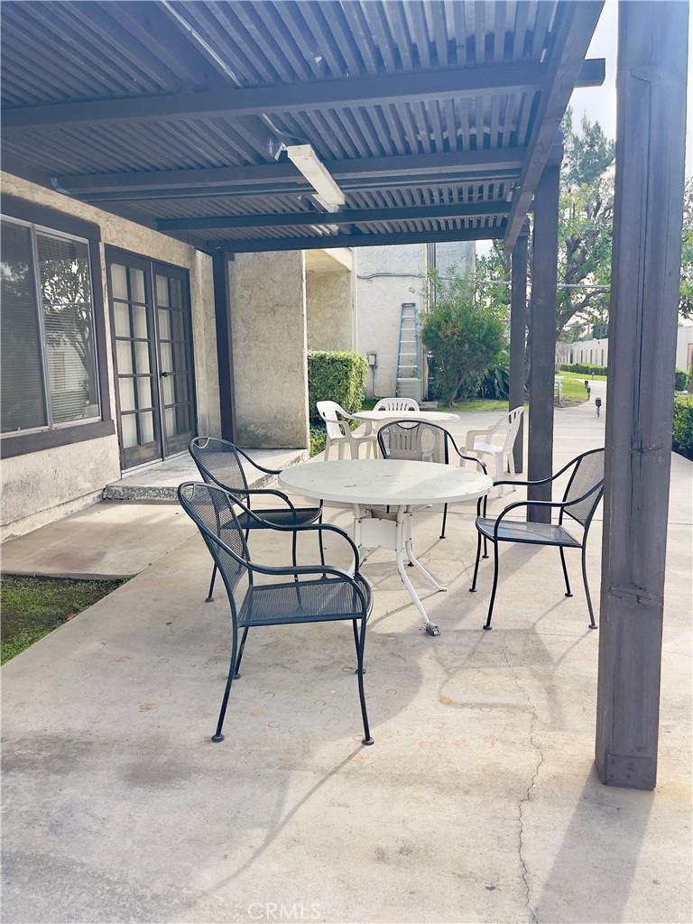 4501 Peck Road, Unit 9 El Monte, CA 91732 - Photo 13 of 16 a building outdoor space with patio furniture and wooden floor