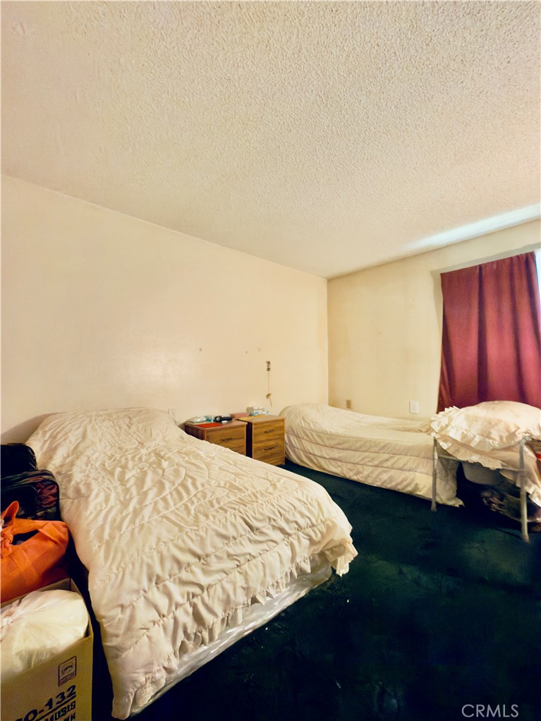 4501 Peck Road, Unit 9 El Monte, CA 91732 - Photo 9 of 17 a bedroom with a bed and a night stand