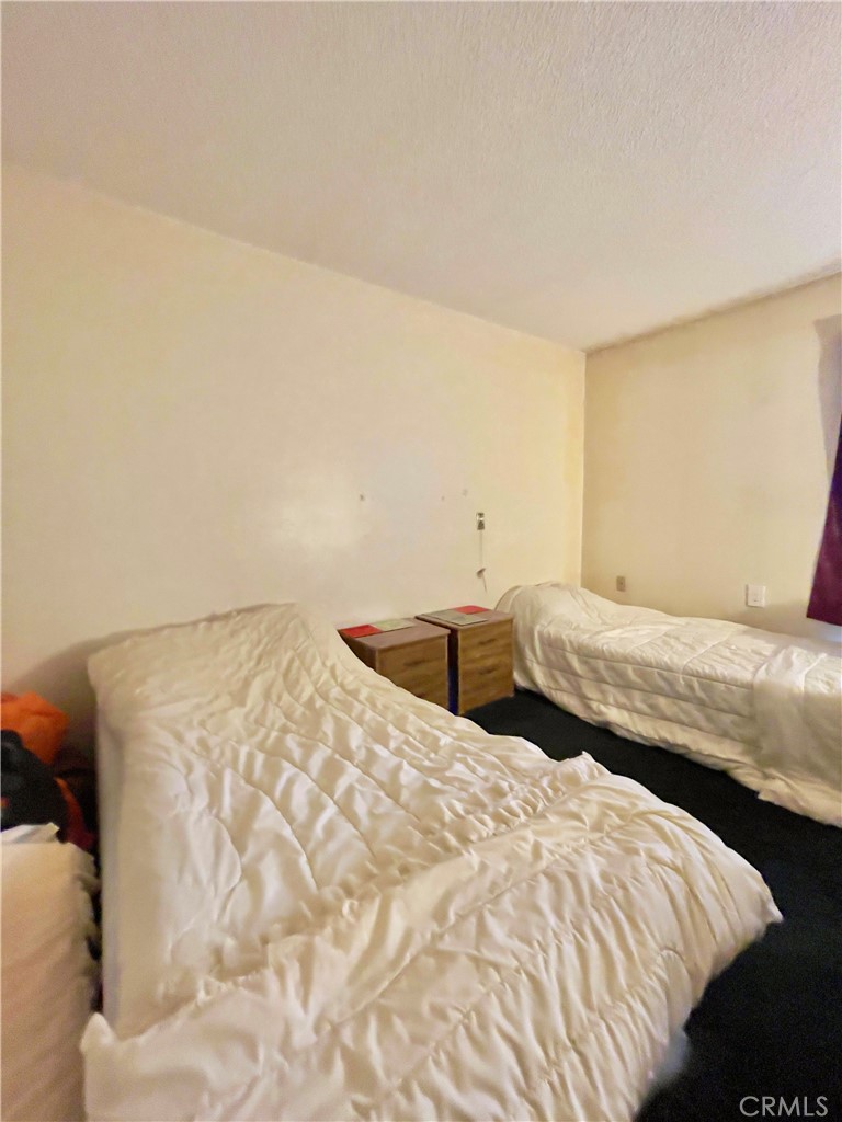 4501 Peck Road, Unit 9 El Monte, CA 91732 - Photo 10 of 17 a bedroom with a bed and a couch