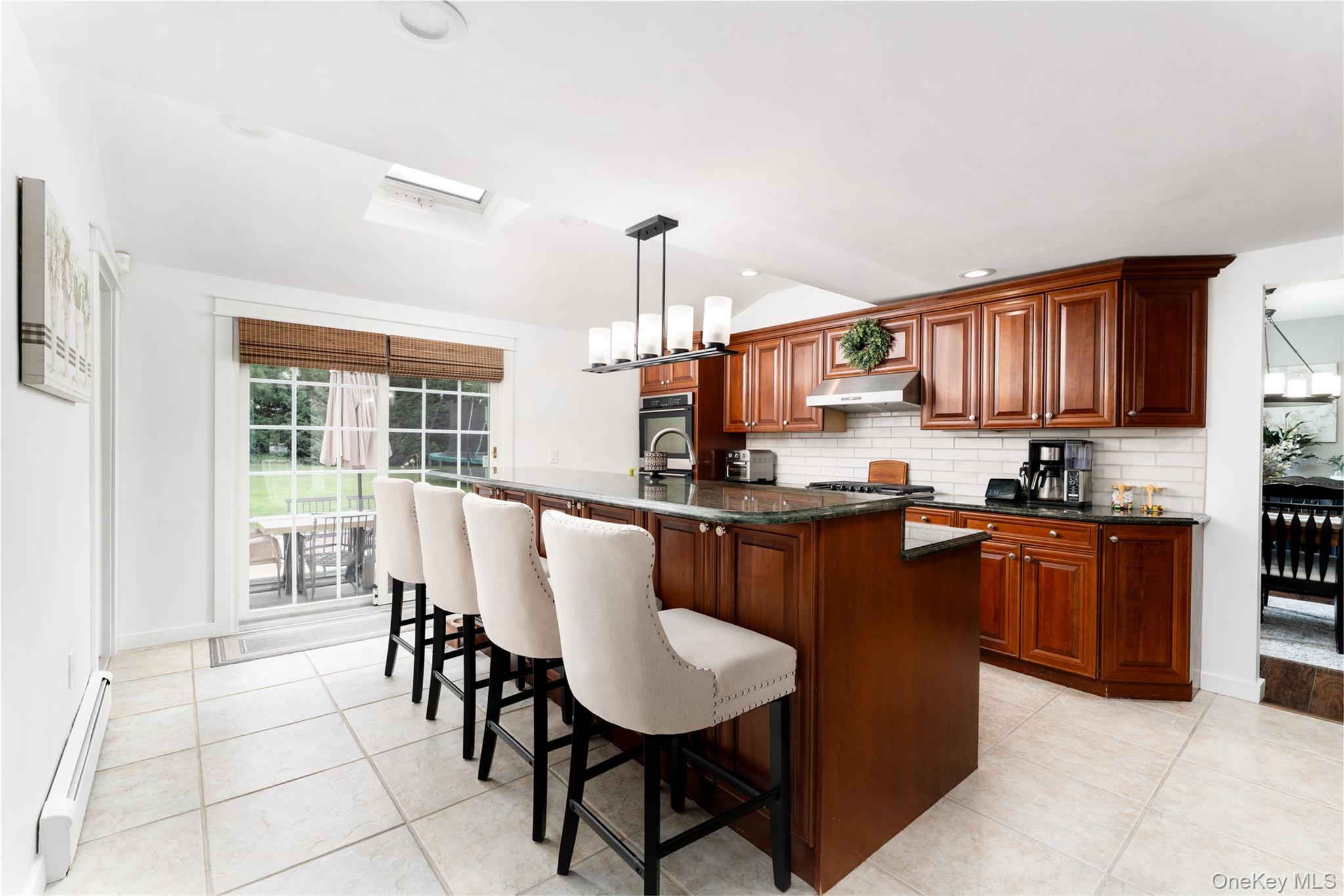 8 Miller Avenue Shoreham, NY 11786 - Photo 6 of 36 a living room with stainless steel appliances granite countertop furniture a kitchen island a stove a kitchen island a living room with a dining table and chairs