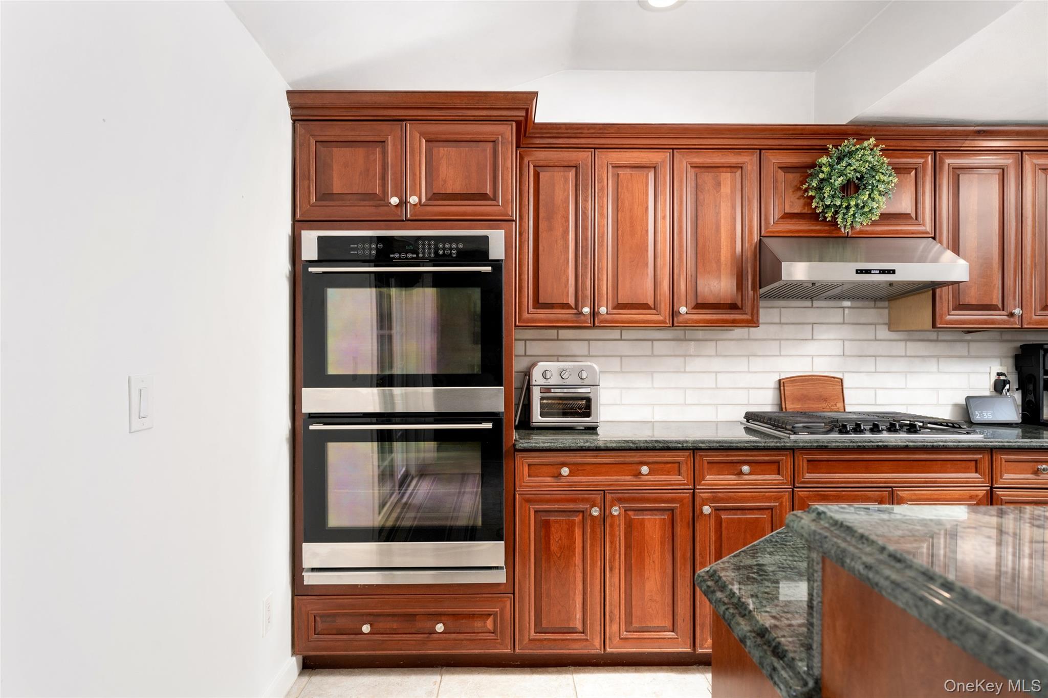 8 Miller Avenue Shoreham, NY 11786 - Photo 9 of 36 a kitchen with granite countertop a stove and cabinets