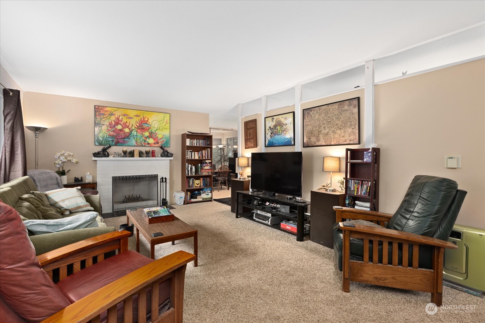107 219th Place Southeast Bothell, WA 98021 - Photo 17 of 40 a living room with furniture a flat screen tv and a fireplace