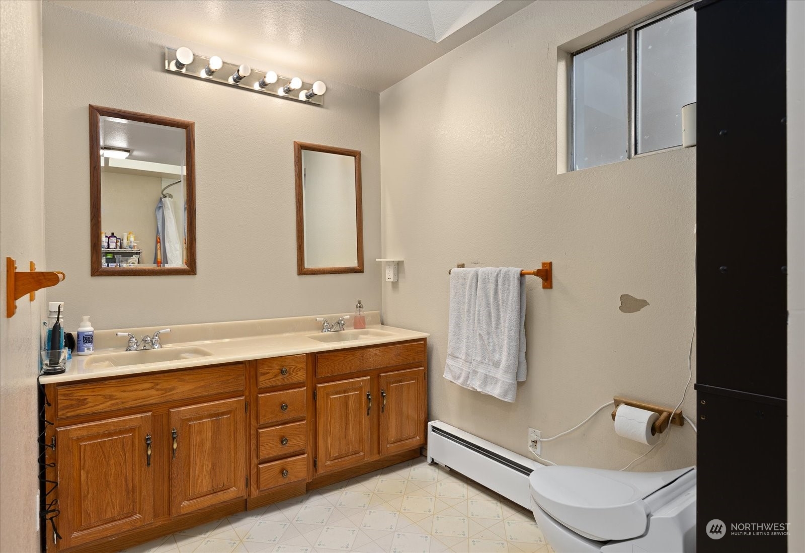 107 219th Place Southeast Bothell, WA 98021 - Photo 27 of 40 a bathroom with a double vanity sink a mirror and bathtub