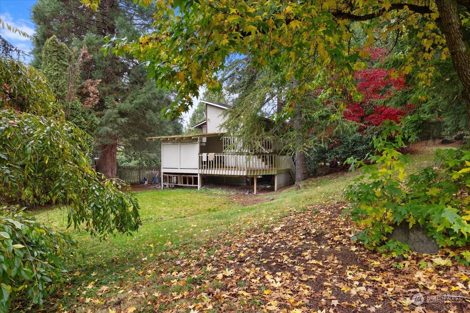 107 219th Place Southeast Bothell, WA 98021 - Photo 36 of 40 a backyard of a house with table and chairs and large trees