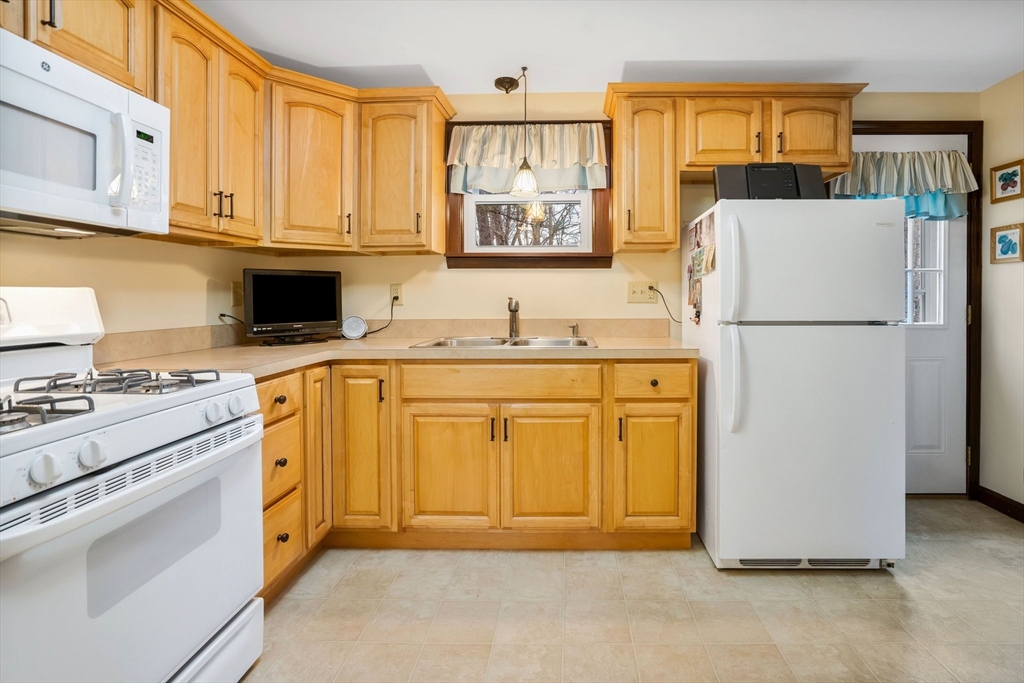 37 Ruthven Street Springfield, MA 01128 - Photo 3 of 24 a utility room with cabinets washer and dryer