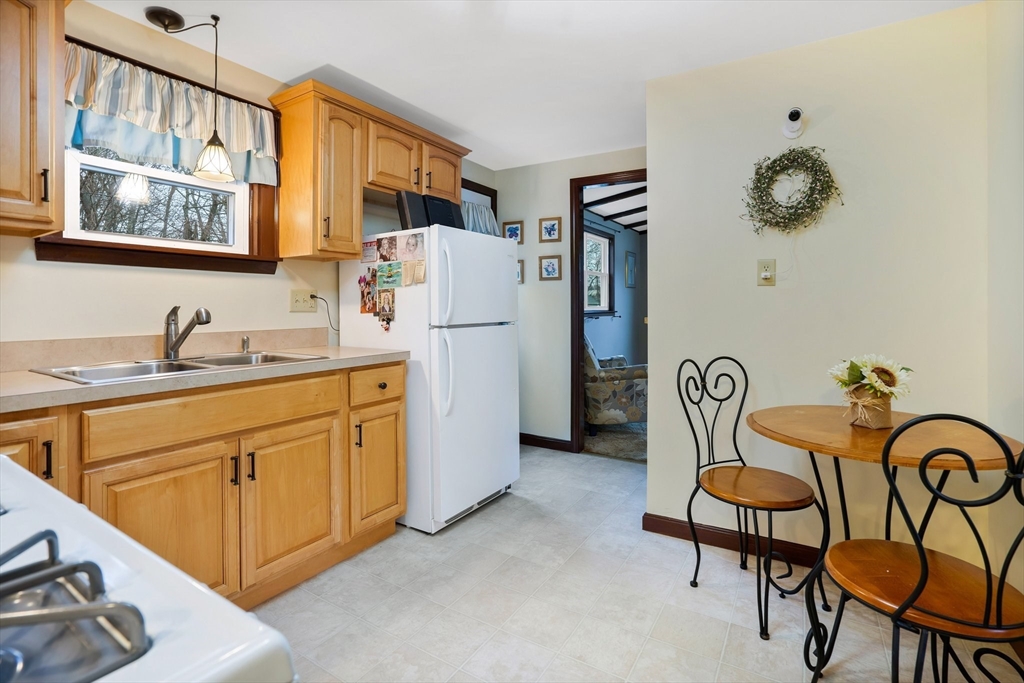 37 Ruthven Street Springfield, MA 01128 - Photo 5 of 24 a kitchen with furniture a refrigerator and a sink