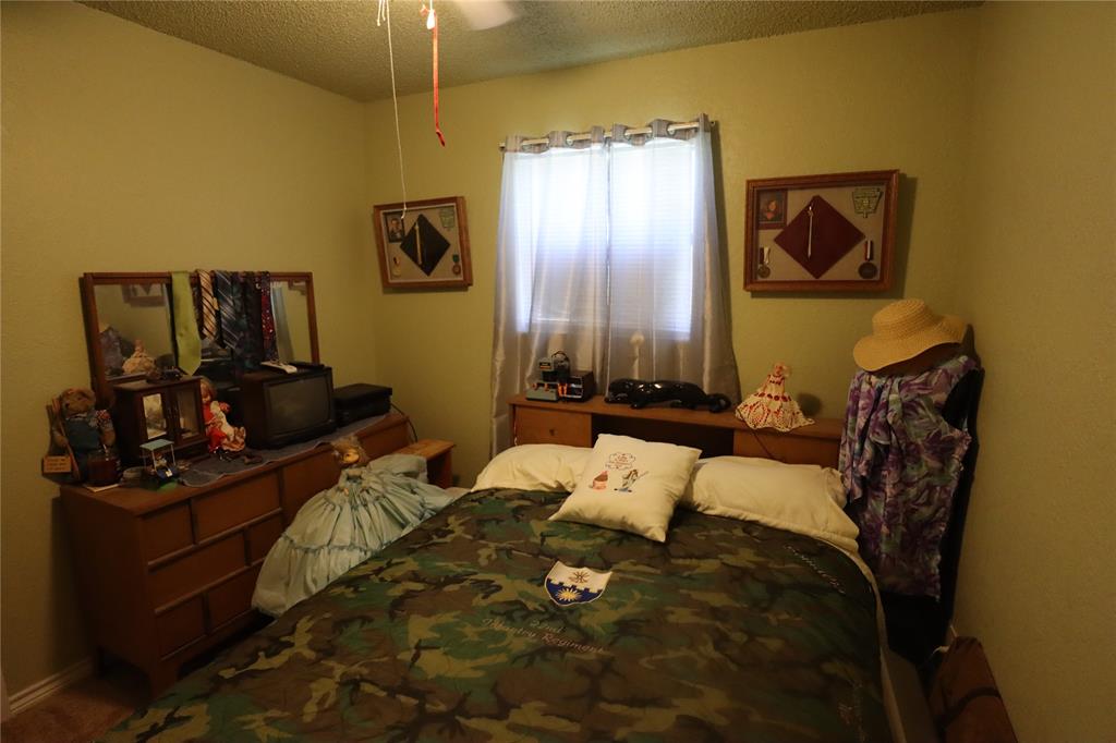 39 Oakcrest Drive Ranger, TX 76470 - Photo 17 of 25 a bed room with a bed and a television