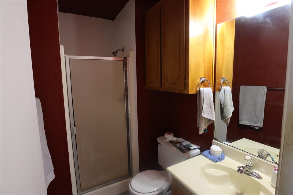 39 Oakcrest Drive Ranger, TX 76470 - Photo 24 of 25 a bathroom with a sink toilet and mirror