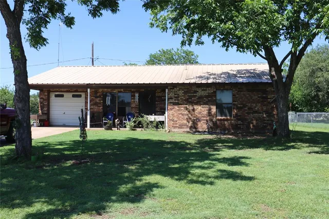 a view of a house with a backyard porch and garden