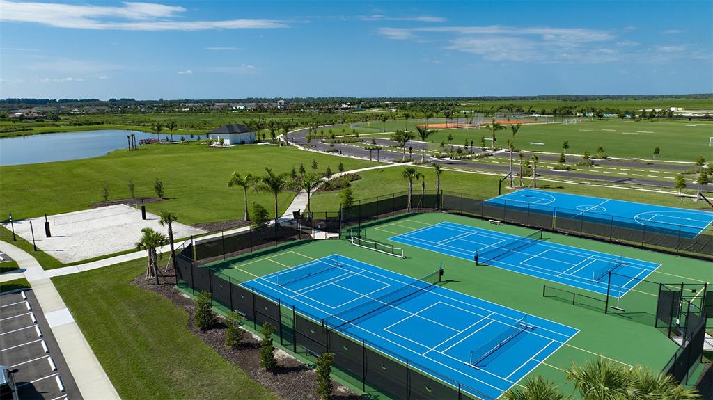 10758 Eclipse Street Sarasota, FL 34241 - Photo 41 of 42 a view of a tennis ground with a view of a lake