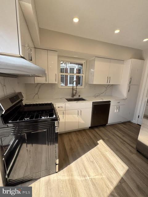104 Stuart Avenue Downingtown, PA 19335 - Photo 5 of 30 a kitchen with a stove and white cabinets