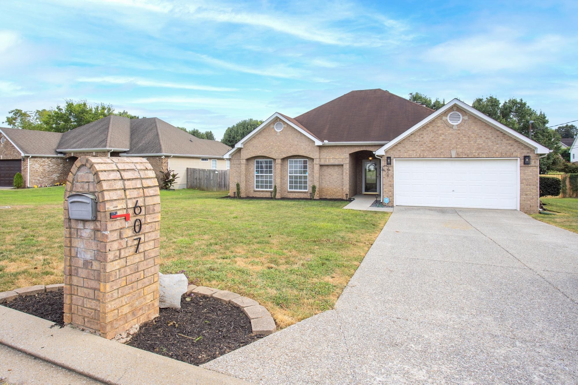 607 Mable Drive La Vergne, TN 37086 - Photo 2 of 46 a front view of a house with a garden and yard
