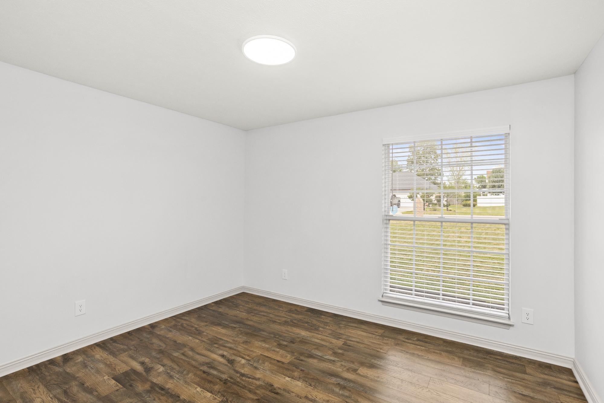 607 Mable Drive La Vergne, TN 37086 - Photo 23 of 46 a view of an empty room with wooden floor and a window