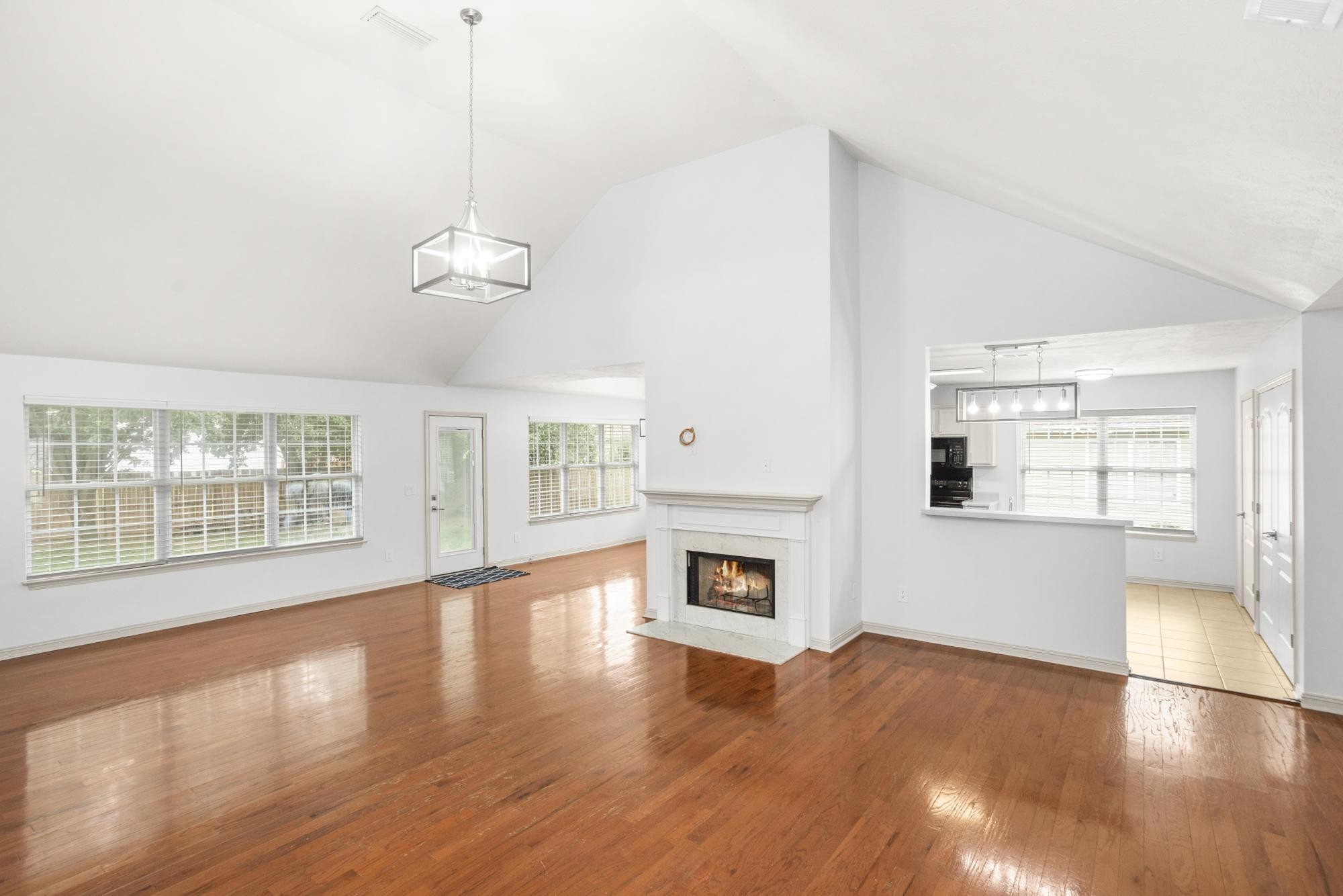 607 Mable Drive La Vergne, TN 37086 - Photo 7 of 46 a view of an empty room with wooden floor fireplace and a window