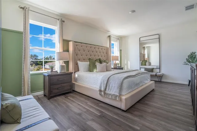 a bedroom with a large bed and a window