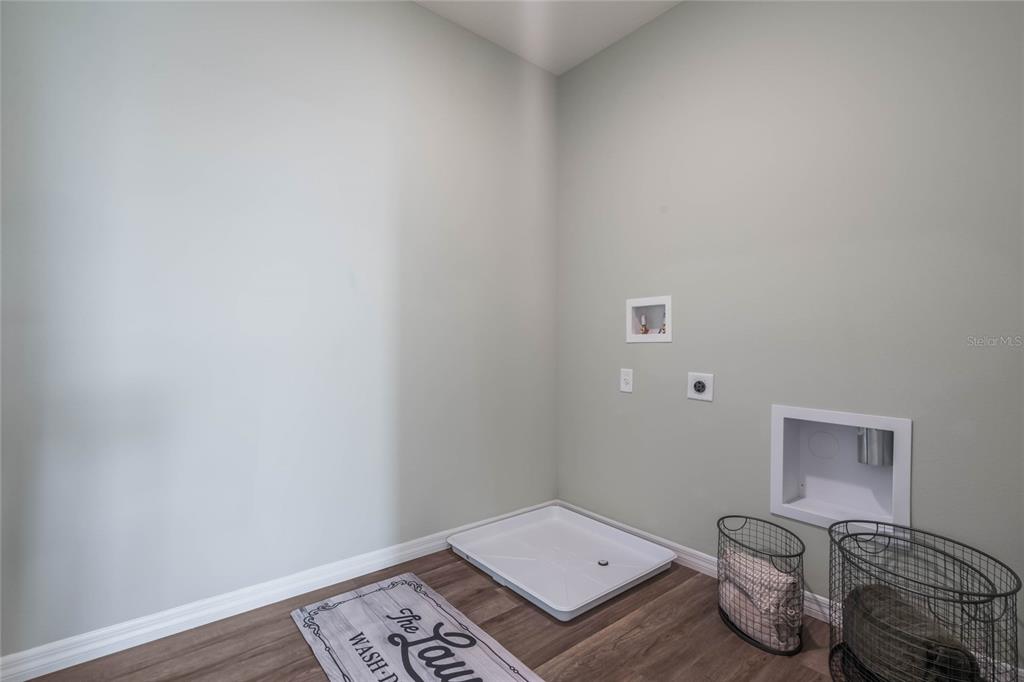 3427 Nettle Loop Tavares, FL 32778 - Photo 25 of 29 a room with a wooden floor and a sink