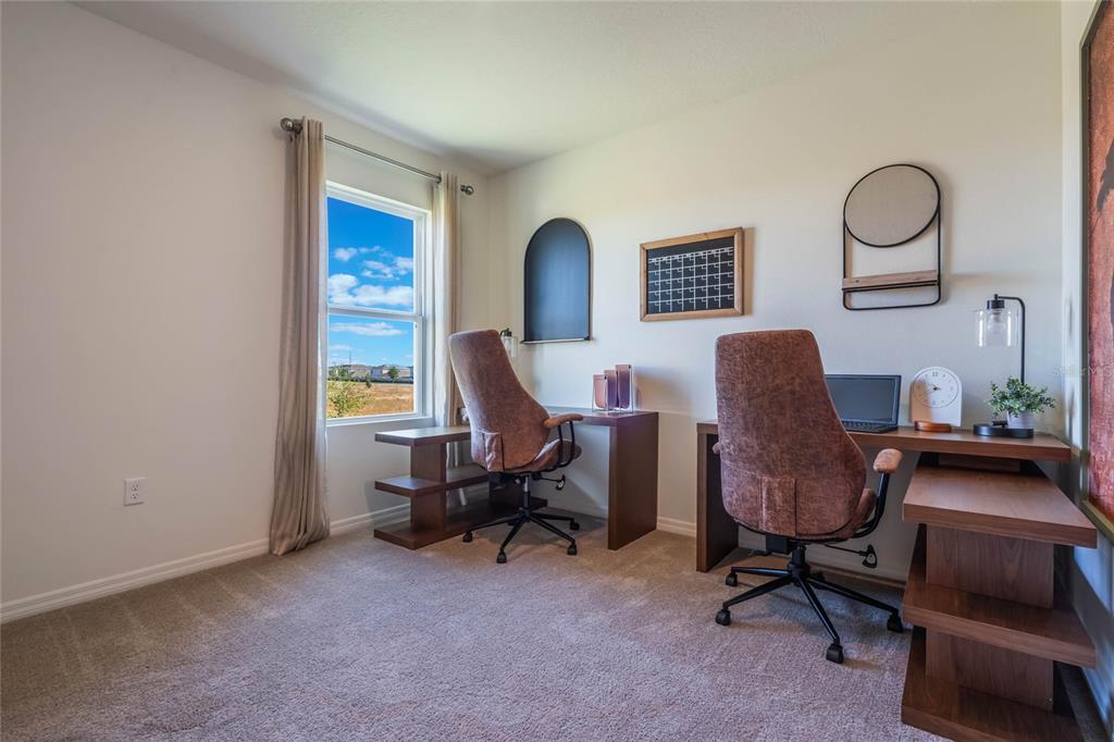 3427 Nettle Loop Tavares, FL 32778 - Photo 27 of 29 a view of a workspace with furniture and a window