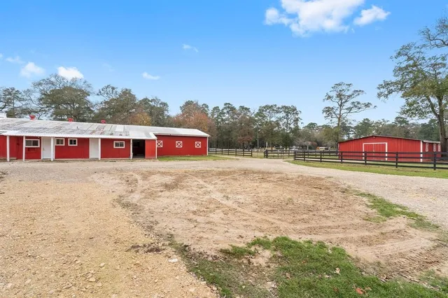 an aerial view of a house with a yard and lake view