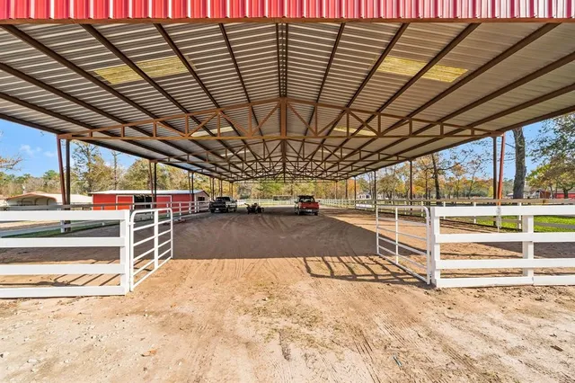 an aerial view of residential house with swimming pool and lawn chairs