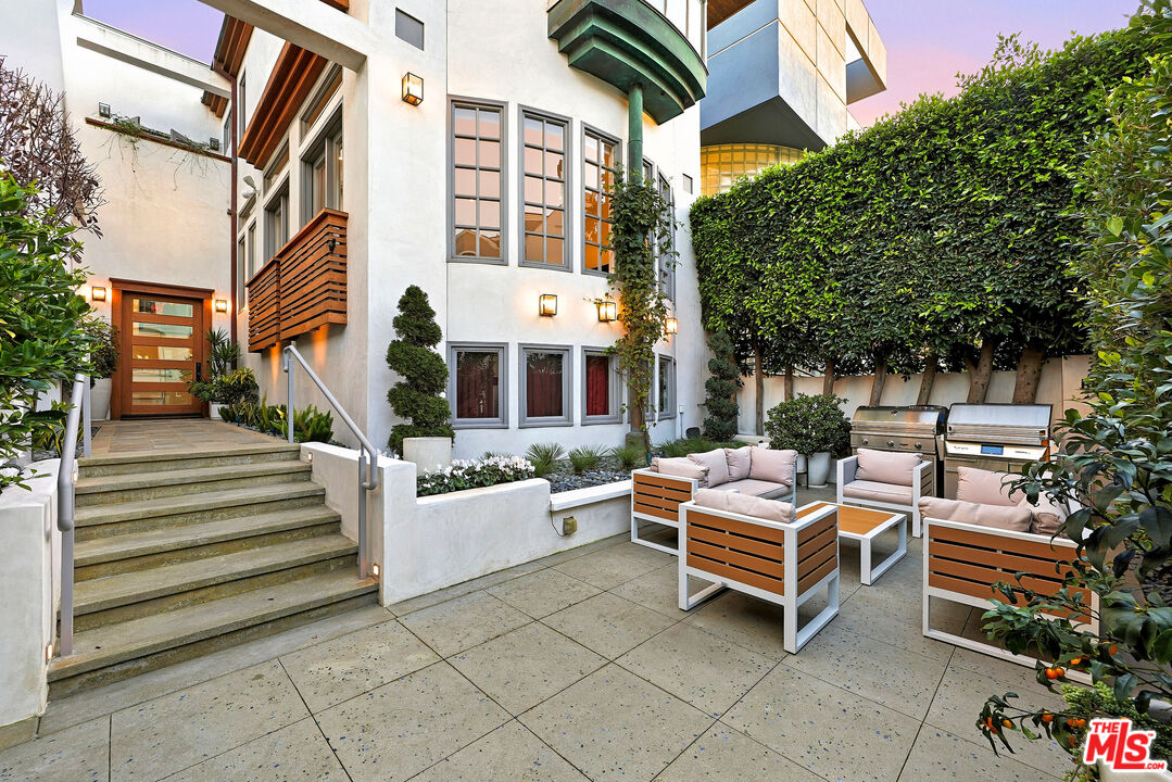 128 Roma Court Marina del Rey, CA 90292 - Photo 1 of 52 a backyard of a house with barbeque oven and outdoor seating