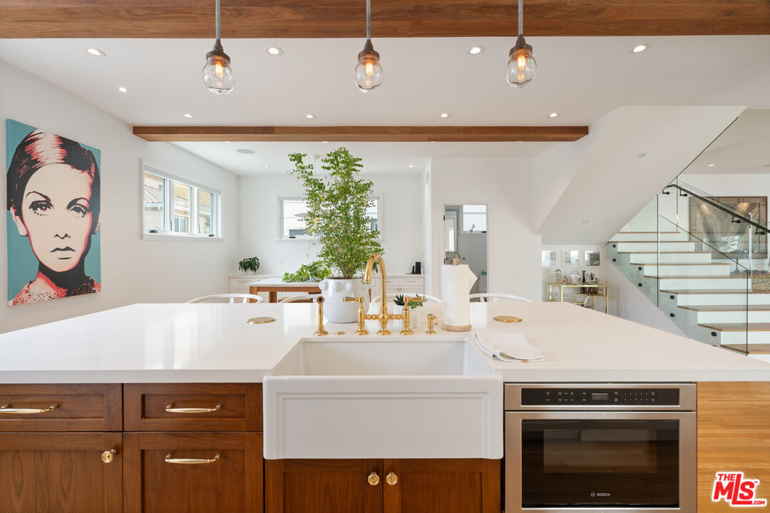 128 Roma Court Marina del Rey, CA 90292 - Photo 23 of 52 a kitchen with a sink a stove and a refrigerator