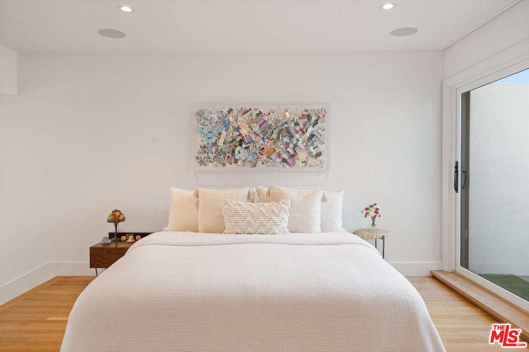 128 Roma Court Marina del Rey, CA 90292 - Photo 27 of 52 a bedroom with a bed and a painting on the wall
