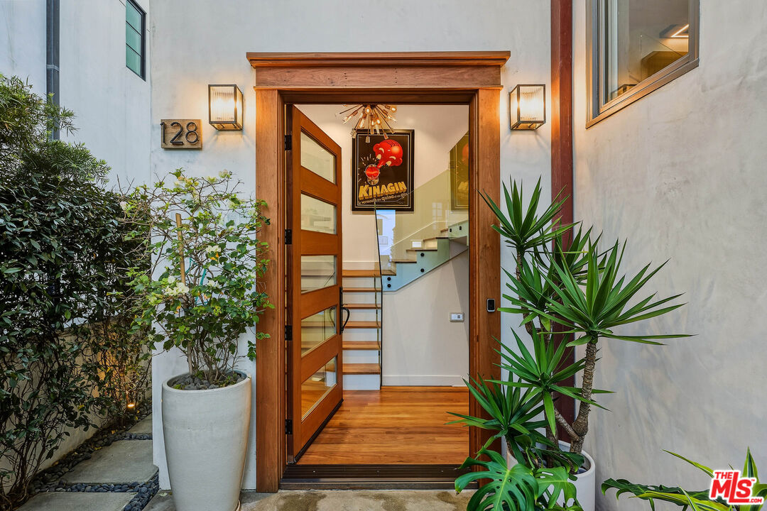 128 Roma Court Marina del Rey, CA 90292 - Photo 46 of 52 a vase of flowers sitting on a floor in front of a door