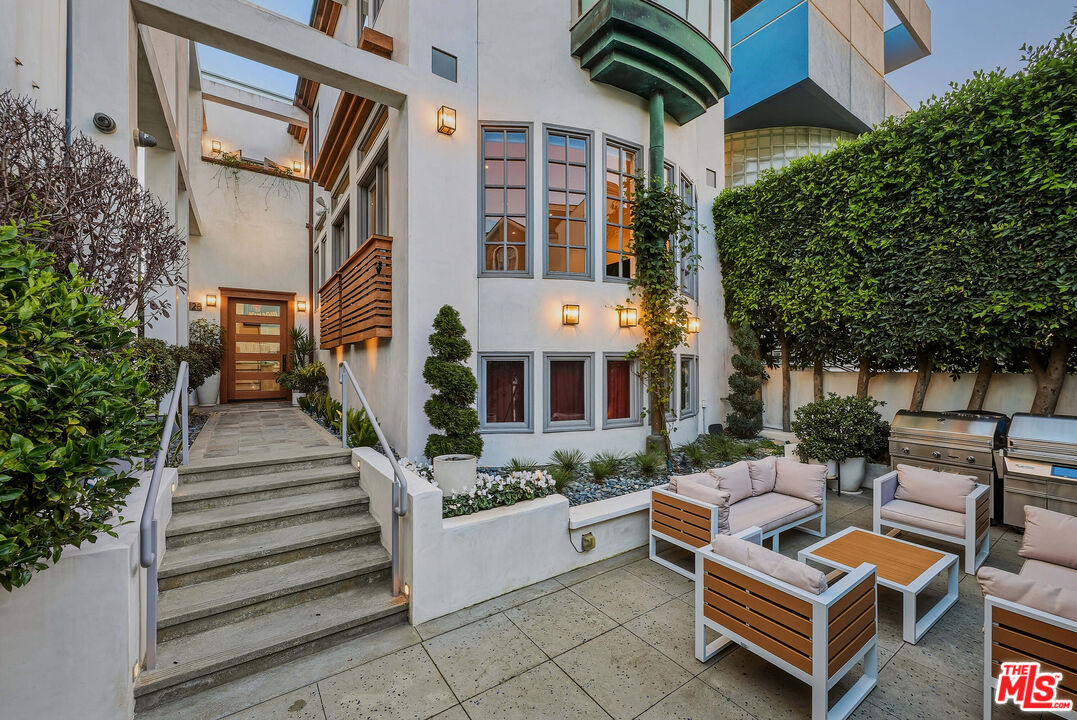 128 Roma Court Marina del Rey, CA 90292 - Photo 47 of 52 a view of a patio with couches table and chairs and potted plants
