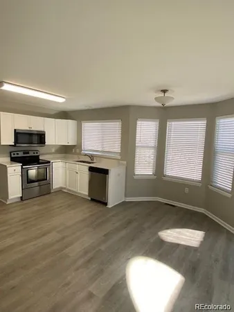 a view of a kitchen with a sink dishwasher and a microwave