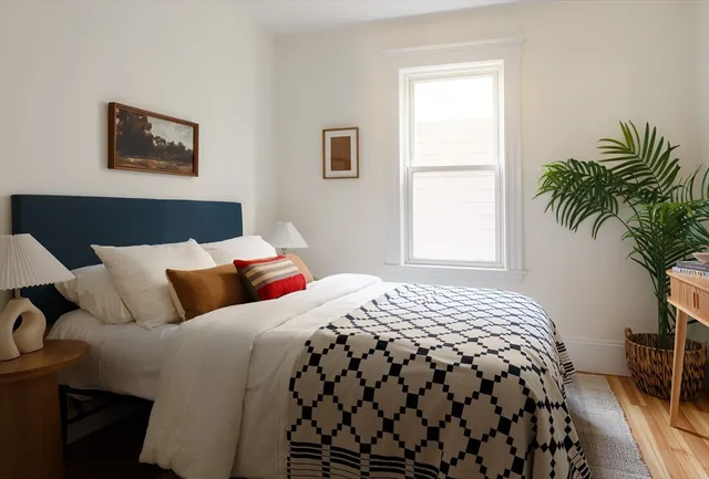 a bedroom with bed and a window