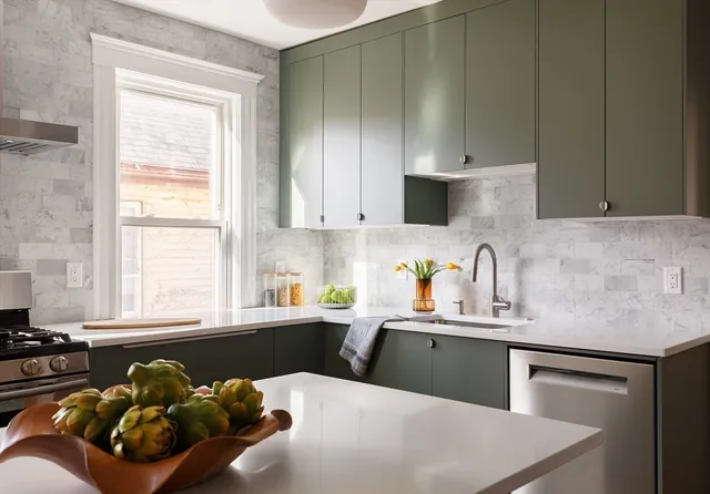 a kitchen with a sink cabinets and window