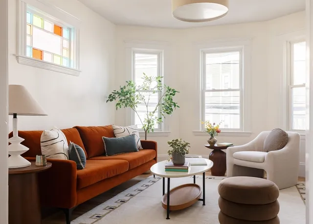 a living room with furniture and a potted plant