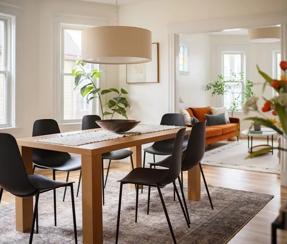 a view of a dining room with furniture and a potted plant