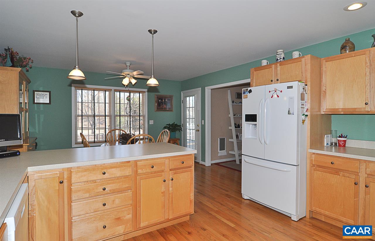 25 Oak Grove Road Palmyra, VA 22963 - Photo 17 of 28 a kitchen with a refrigerator a sink dishwasher a dining table and chairs