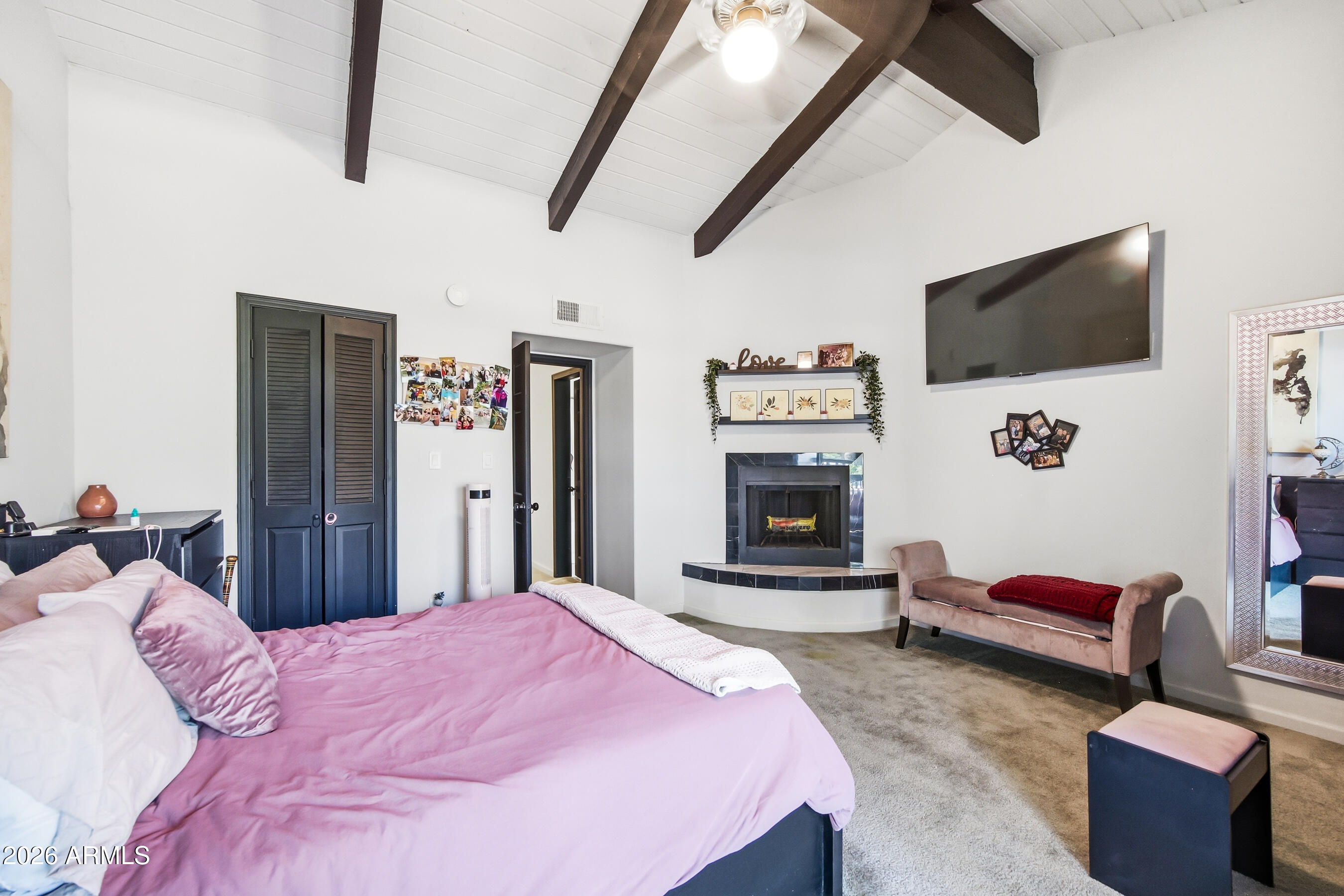 1702 East Ocotillo Road, Unit 1 Phoenix, AZ 85016 - Photo 22 of 27 a bedroom with a bed a flat screen tv and dresser