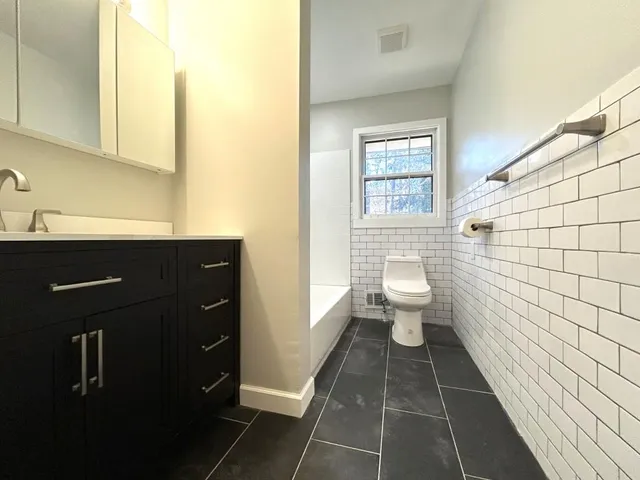 a bathroom with a sink vanity and a mirror