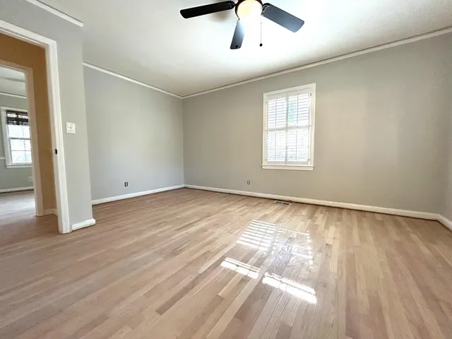 a bathroom with a granite countertop toilet sink and mirror