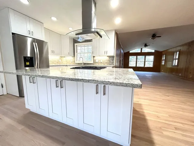 a kitchen with a stove a sink and a refrigerator