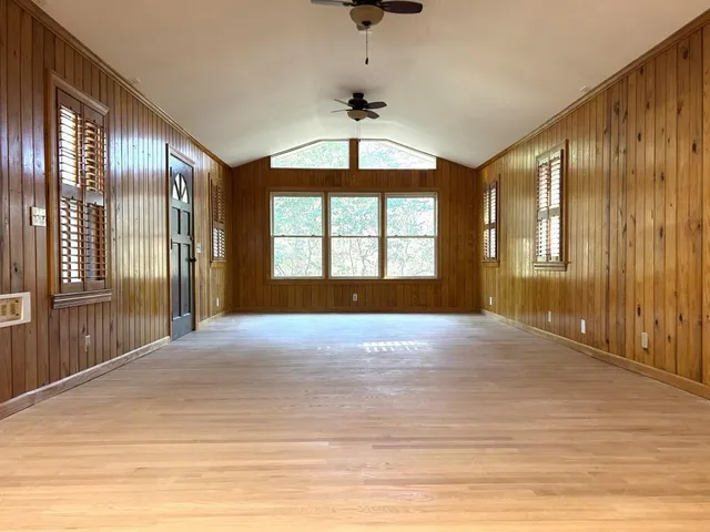 a view of a livingroom with kitchen appliances and cabinets