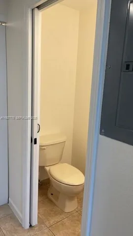 a white toilet sitting next to a shower