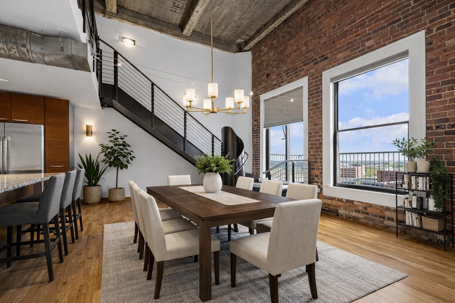 915 Franklin Street, Unit 9L Houston, TX 77002 - Photo 6 of 50 Virtually staged dining area showcasing ample space for a full dining setup and statement light fixture.