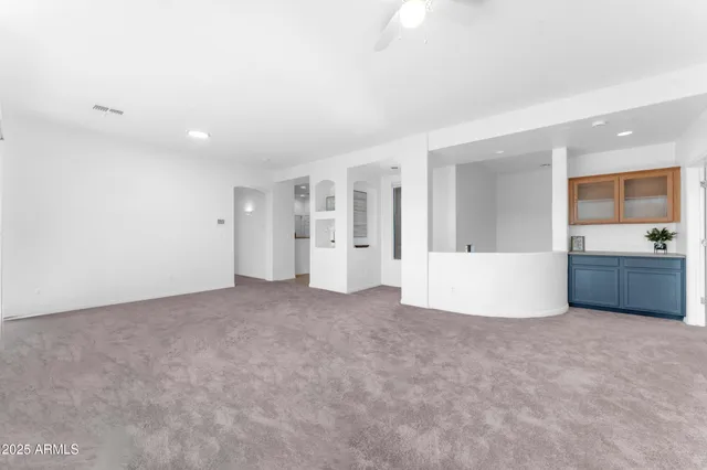 a view of an empty room with a kitchen
