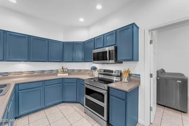 a kitchen with stainless steel appliances a stove sink microwave and cabinets