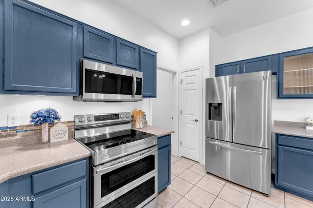 a kitchen with a refrigerator stove and microwave
