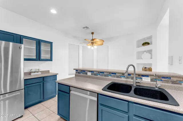 a kitchen with a sink cabinets and stainless steel appliances
