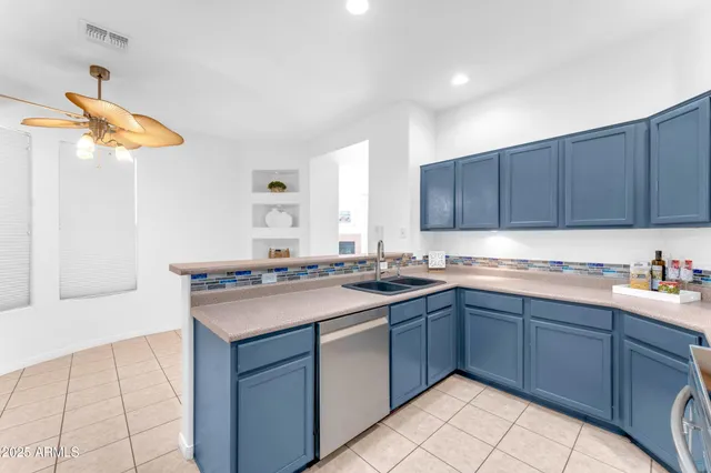 a kitchen with a sink a stove and cabinets